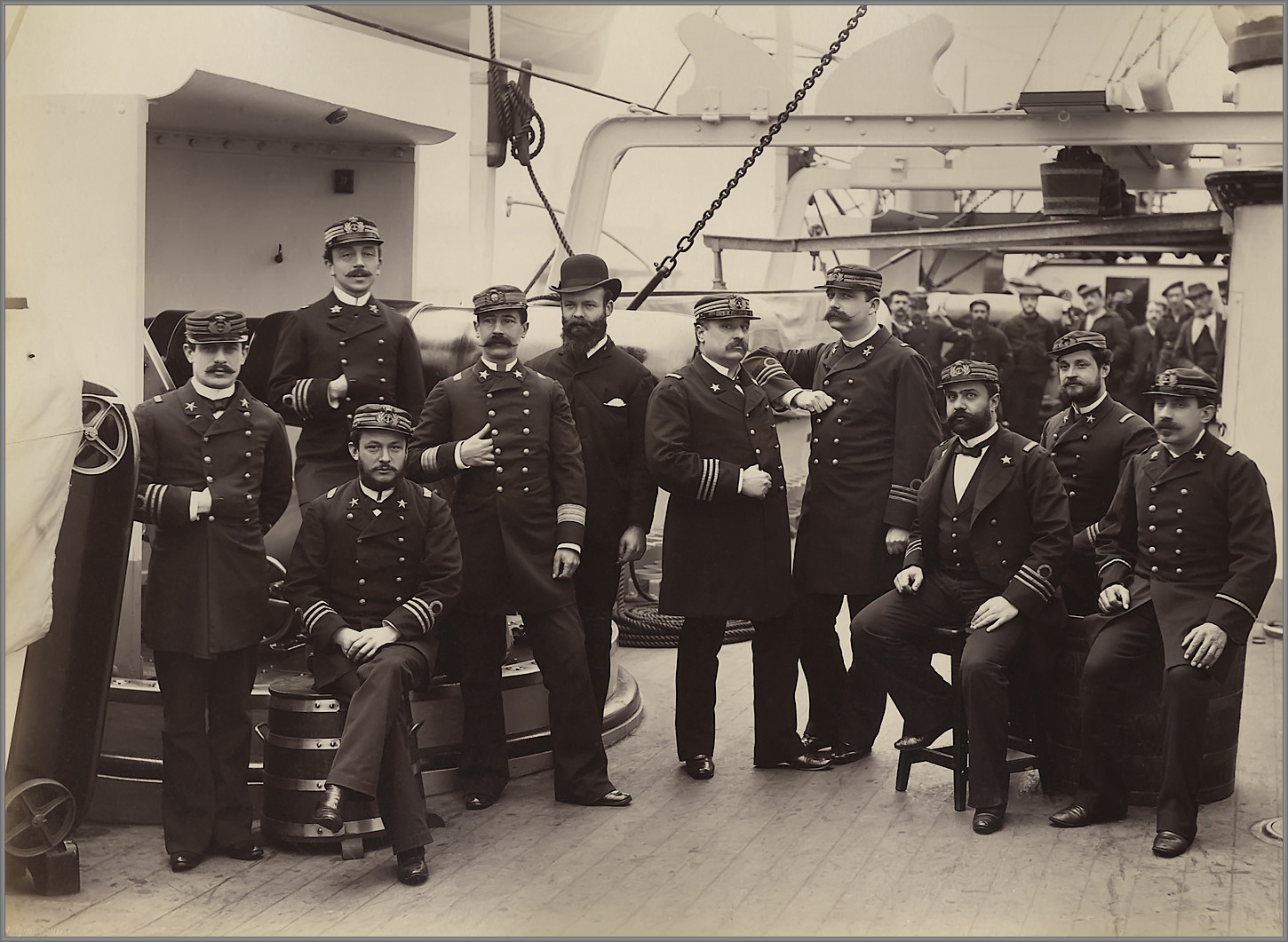 Officers pose for the camera near a 5.9 gun on board the Italian protected cruiser Giovanni Bausan during her sea trials, circa 1885.jpg