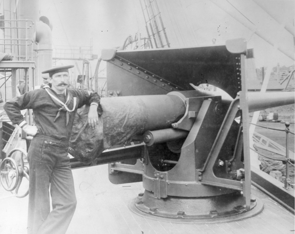 Deck scene with sailor leaning on gun in 1800's.png